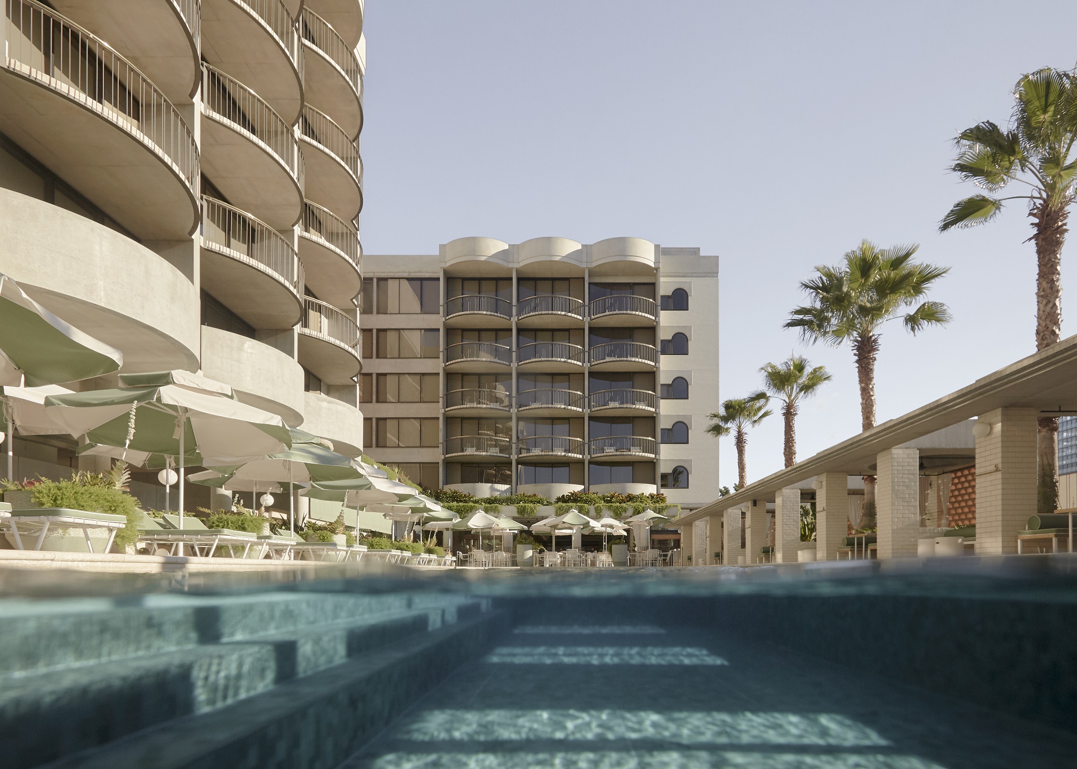 The Calile pool deck and cabanas in full sun.
